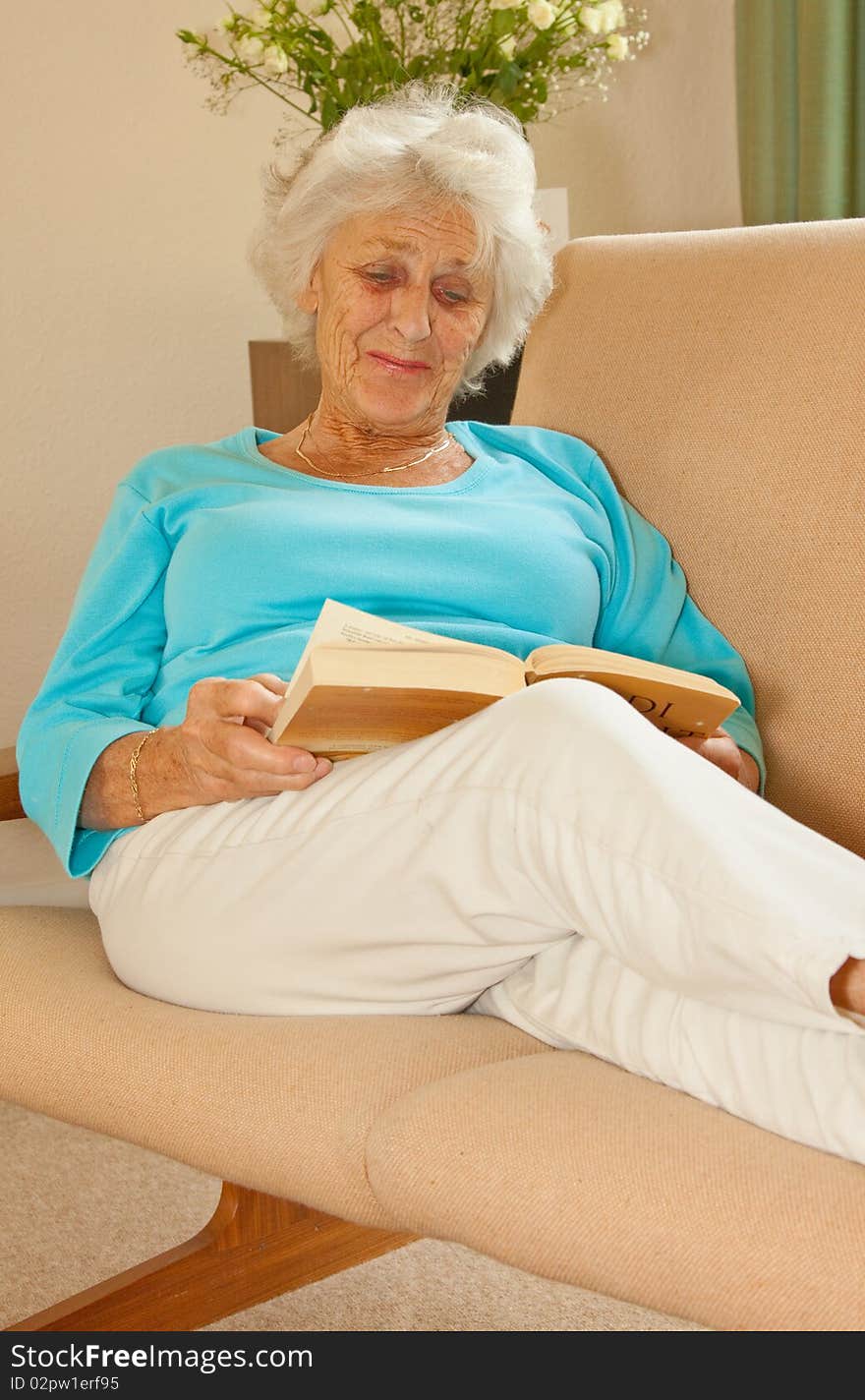 Senior lady relaxing with a good book to read. Senior lady relaxing with a good book to read