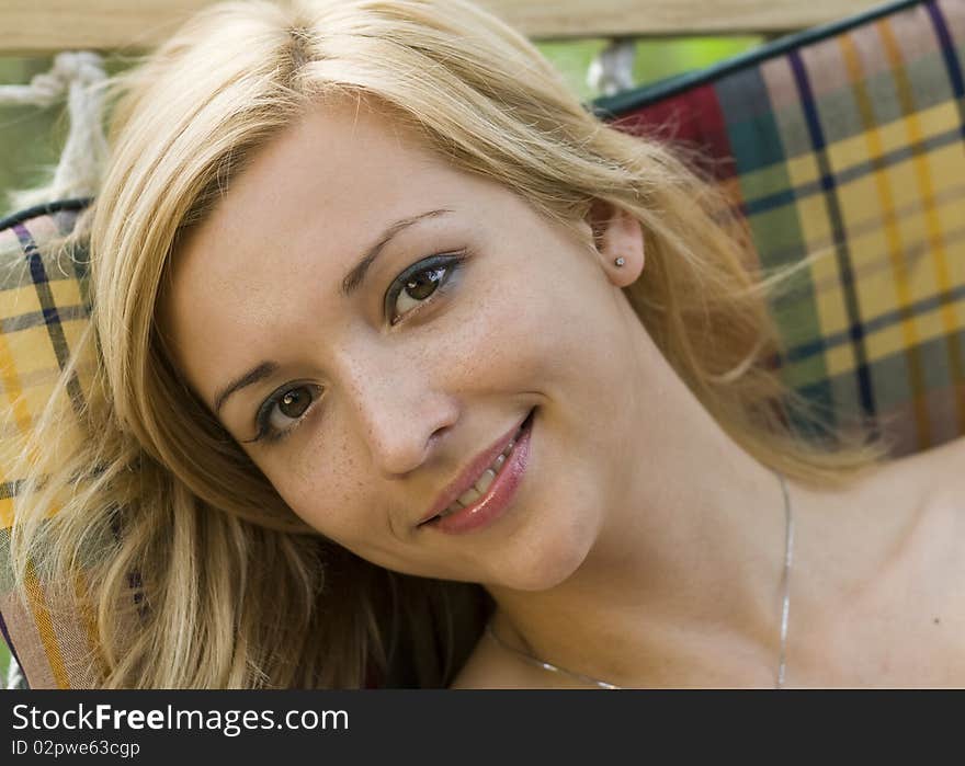 Portrait of a smiling girl lying in a hammock