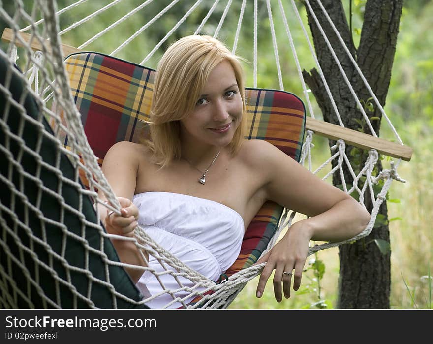 Portrait of a smiling girl lying in a hammock