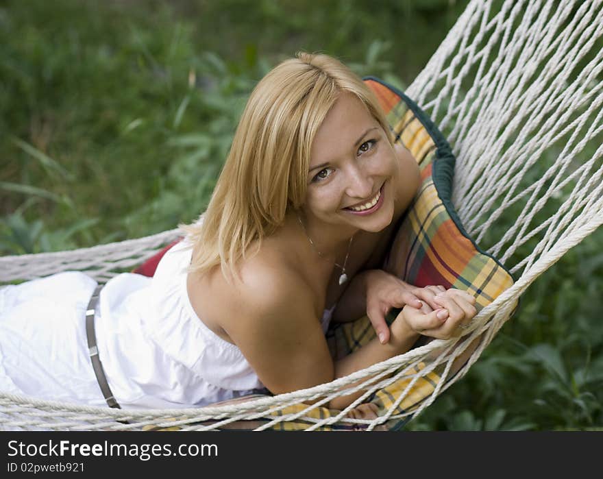 Beautiful girl smiling while lying in a hammock