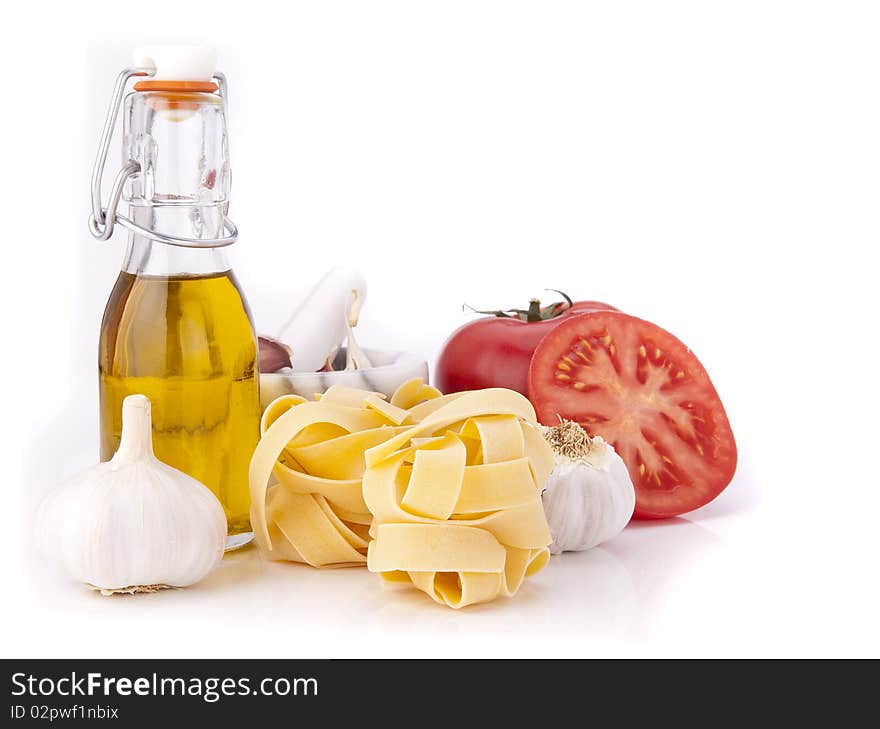 Tomato, garlic,pasta and olive oil on white background