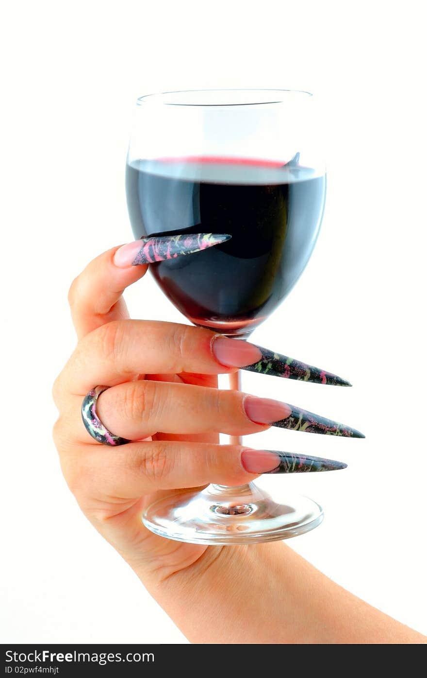 Woman's hand holding nail graft in a glass of wine. Woman's hand holding nail graft in a glass of wine