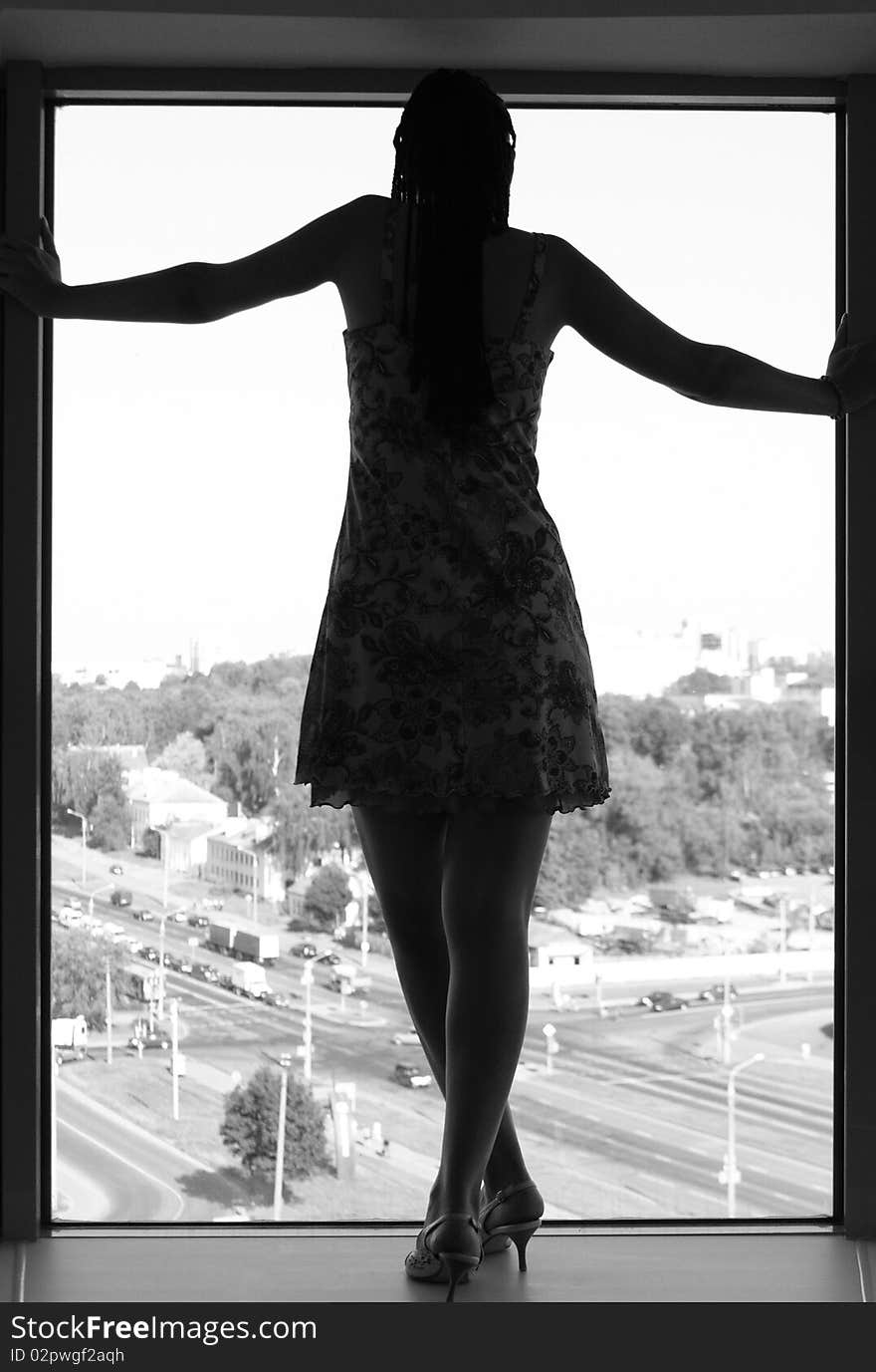 A girl standing on a windowsill