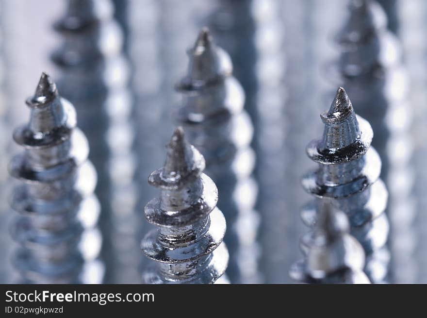 Close-up of silver screws as technology background. Close-up of silver screws as technology background