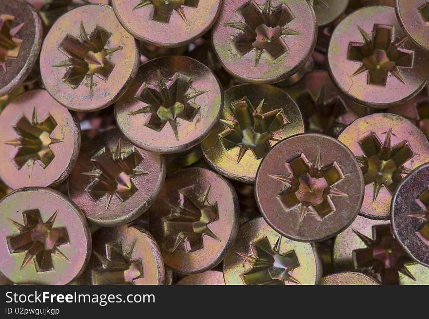 Close-up of golden screws as technology background. Close-up of golden screws as technology background