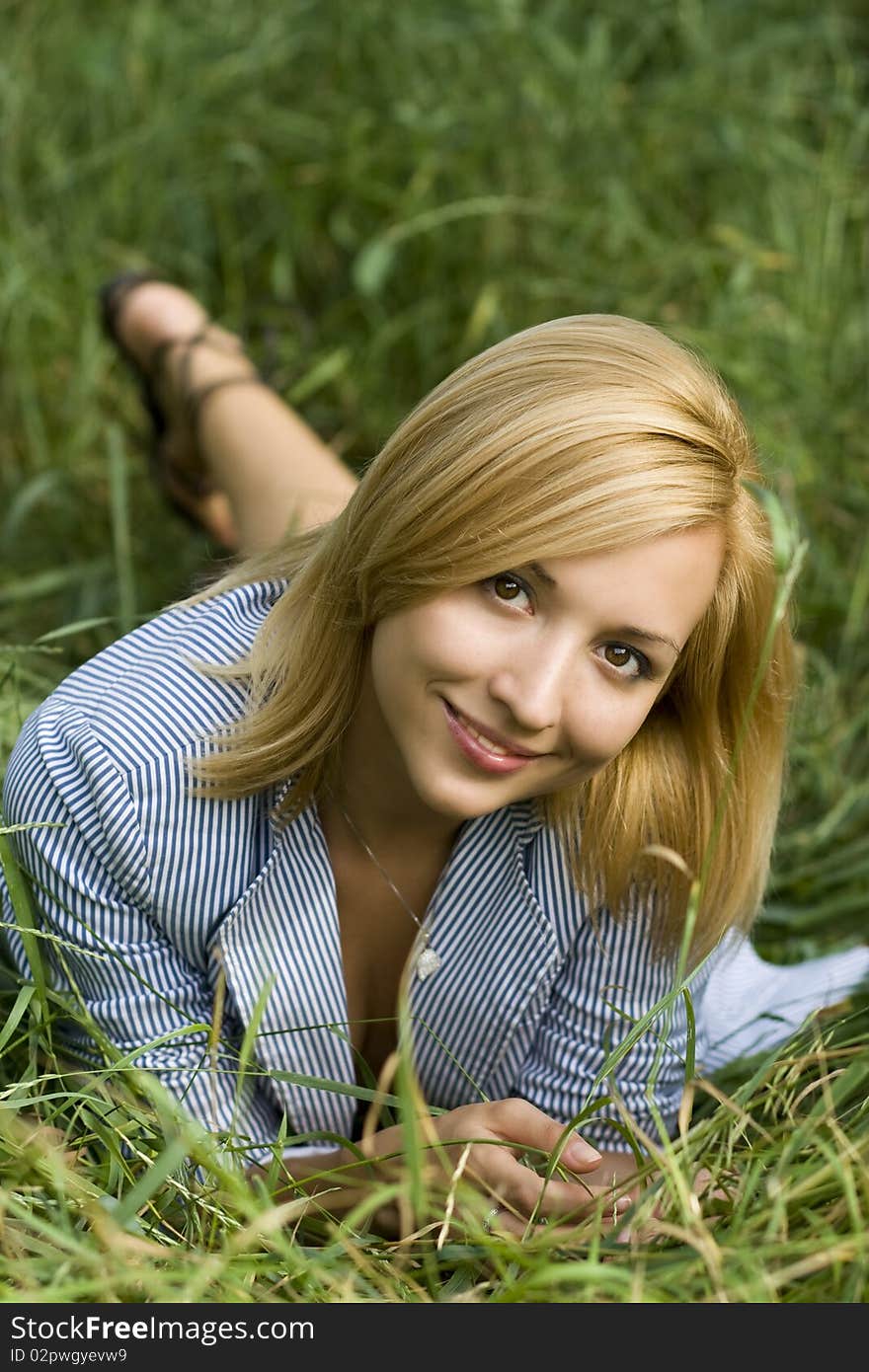 A Beautiful Young Girl Lying In The Grass