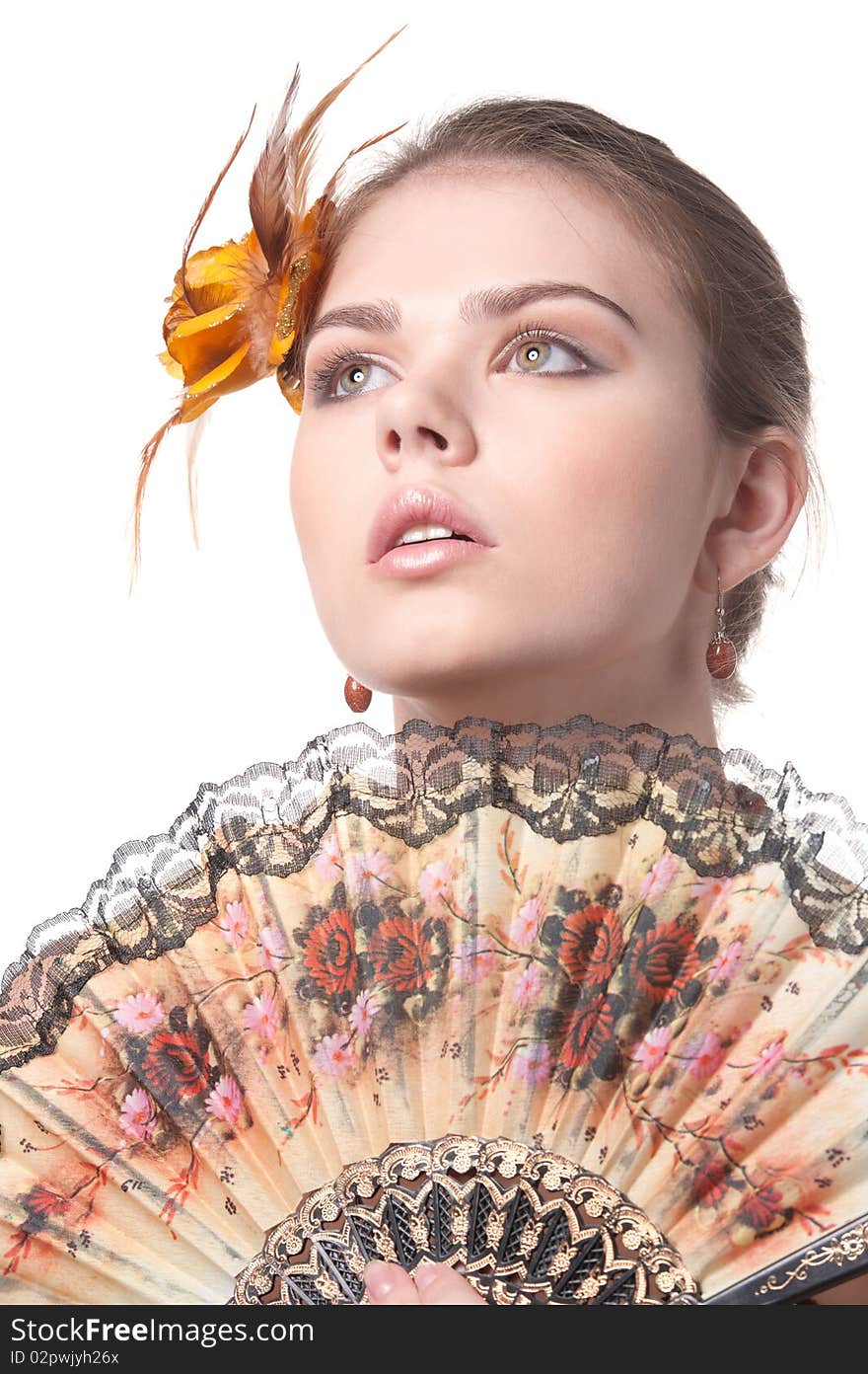 Girl with colorful fan poses on white background