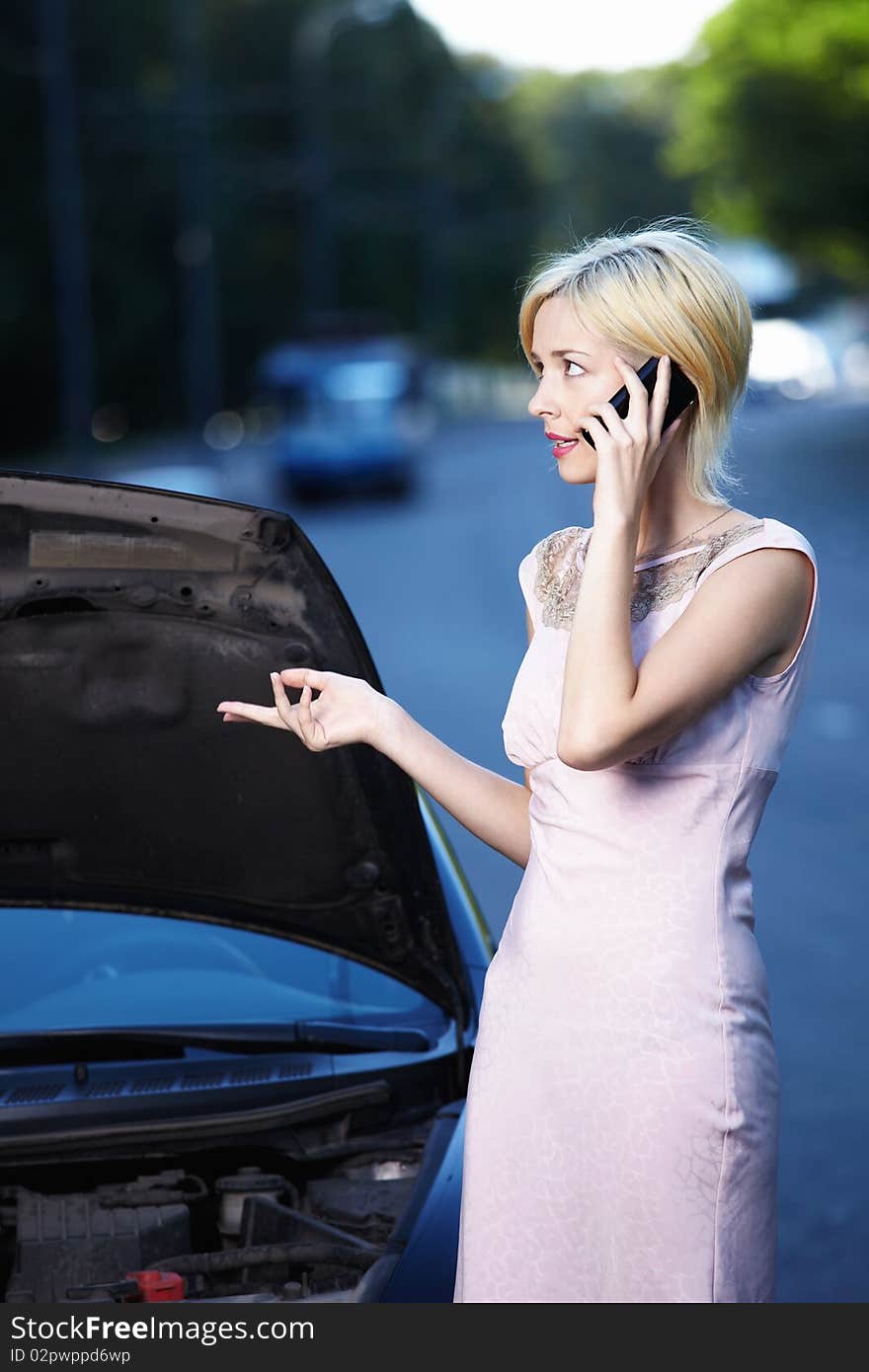 A young girl explains on the phone about car breakdown. A young girl explains on the phone about car breakdown