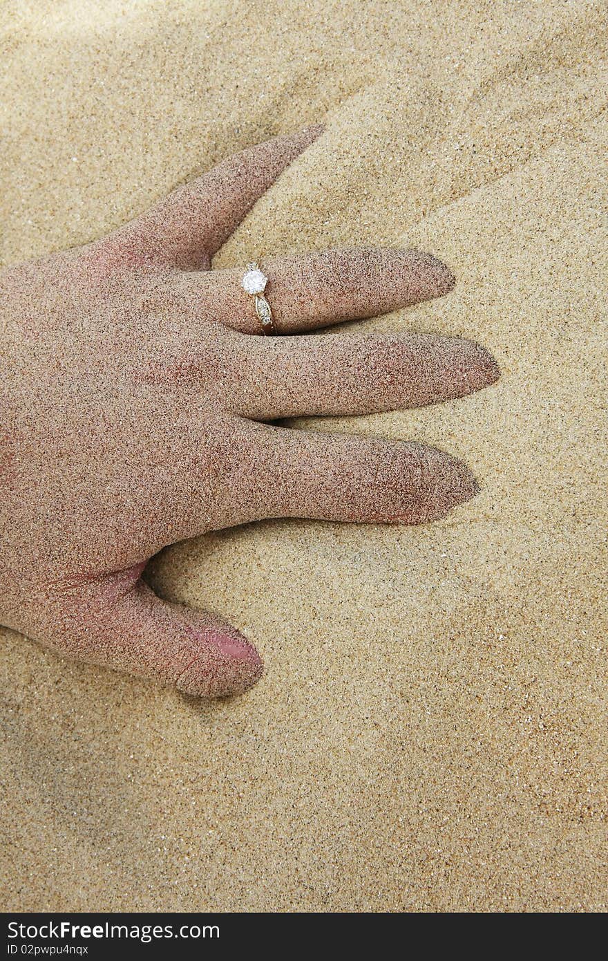 Hand in sand