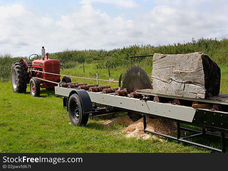 An image of a tractor powered circular saw. An image of a tractor powered circular saw.