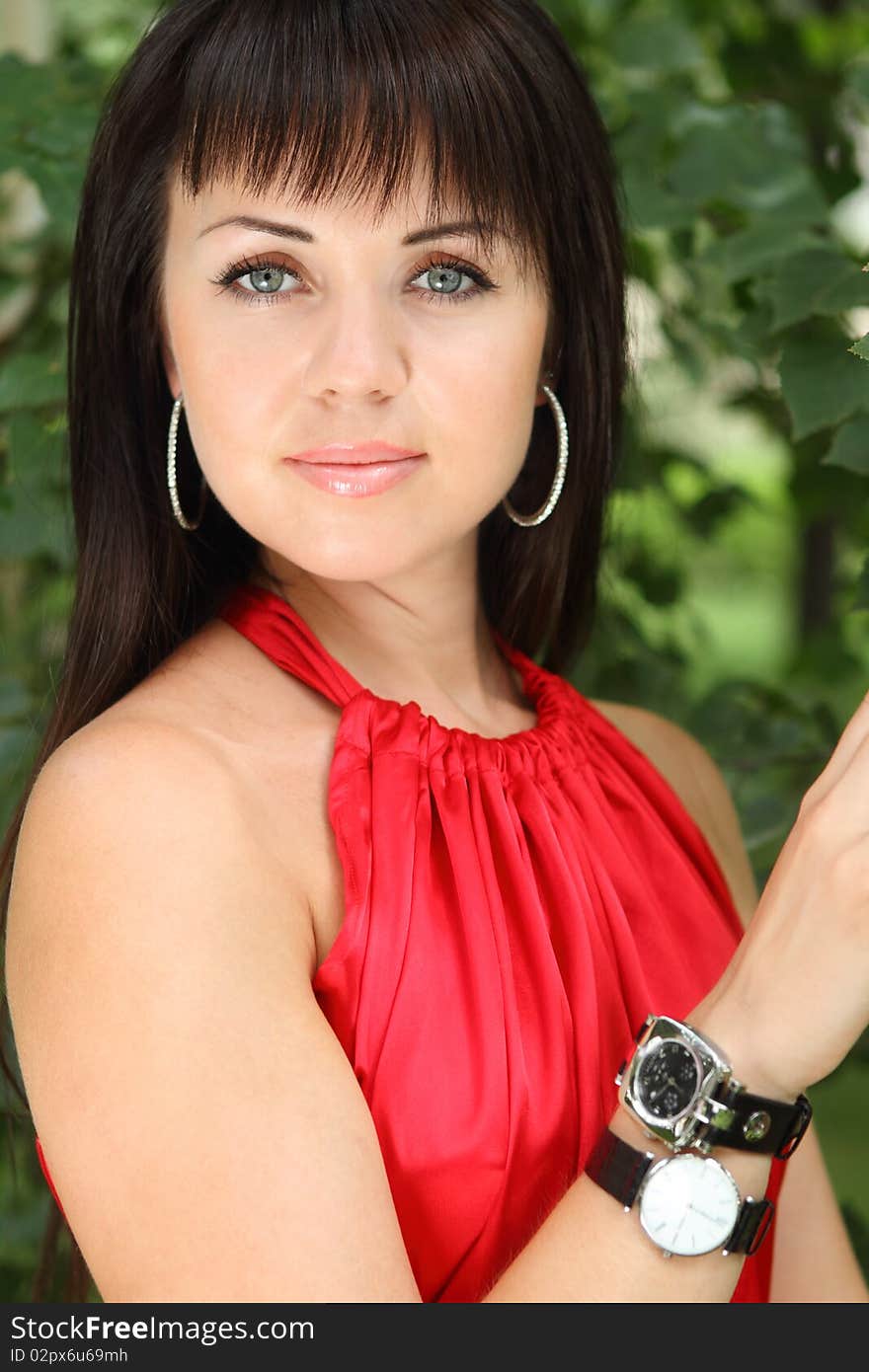 Outdoor portrait of the brunette girl in red