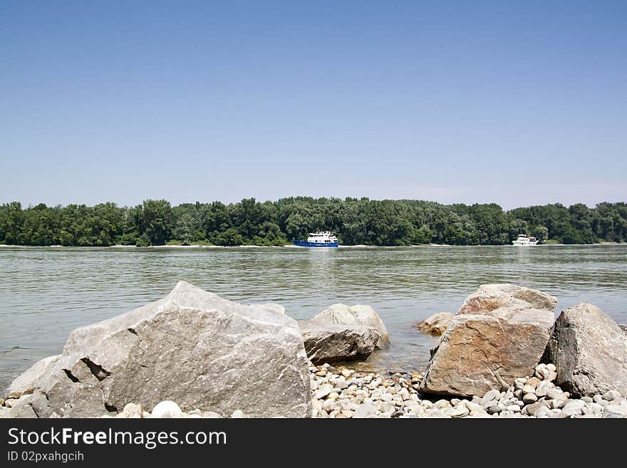 Donau river with boat and rocks