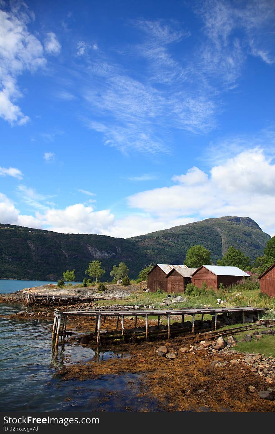 Old wooden pier and the boathouses, shot in Norway in Sognefjord. Shot in sunny beautifull day.