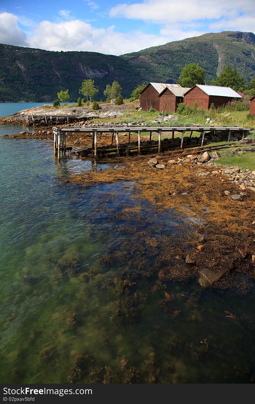 Old Wooden Pier And The Boathouses