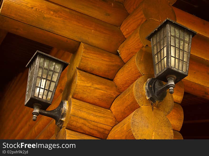 A older lamp on the log wall