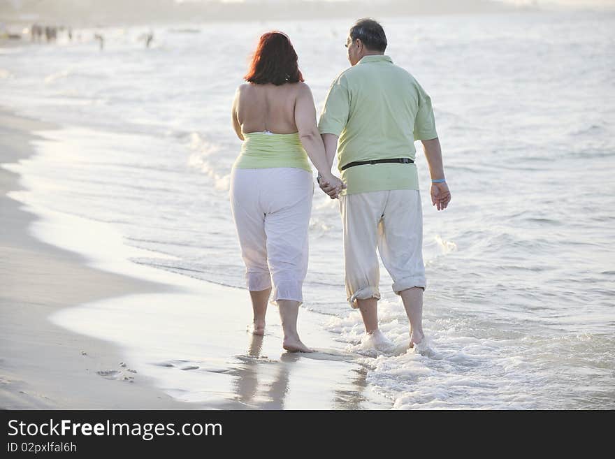 Happy seniors couple  on beach