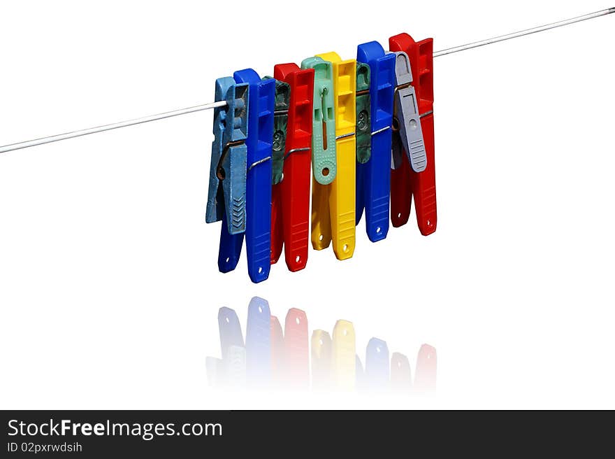 Color clothes pins in white background