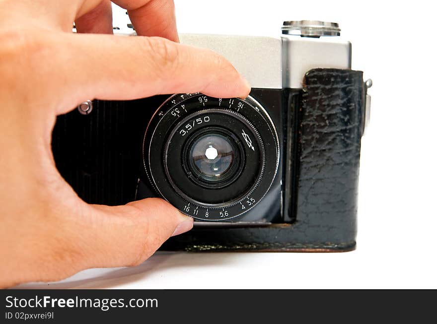 Old manual film camera and hand isolated on white. Old manual film camera and hand isolated on white