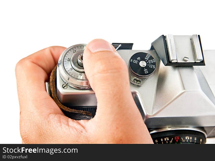 Old manual film camera and hand isolated on white