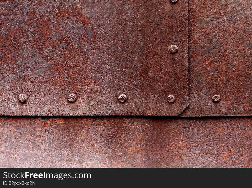 Old flat metal with pitting, rust and rivets. Old flat metal with pitting, rust and rivets.