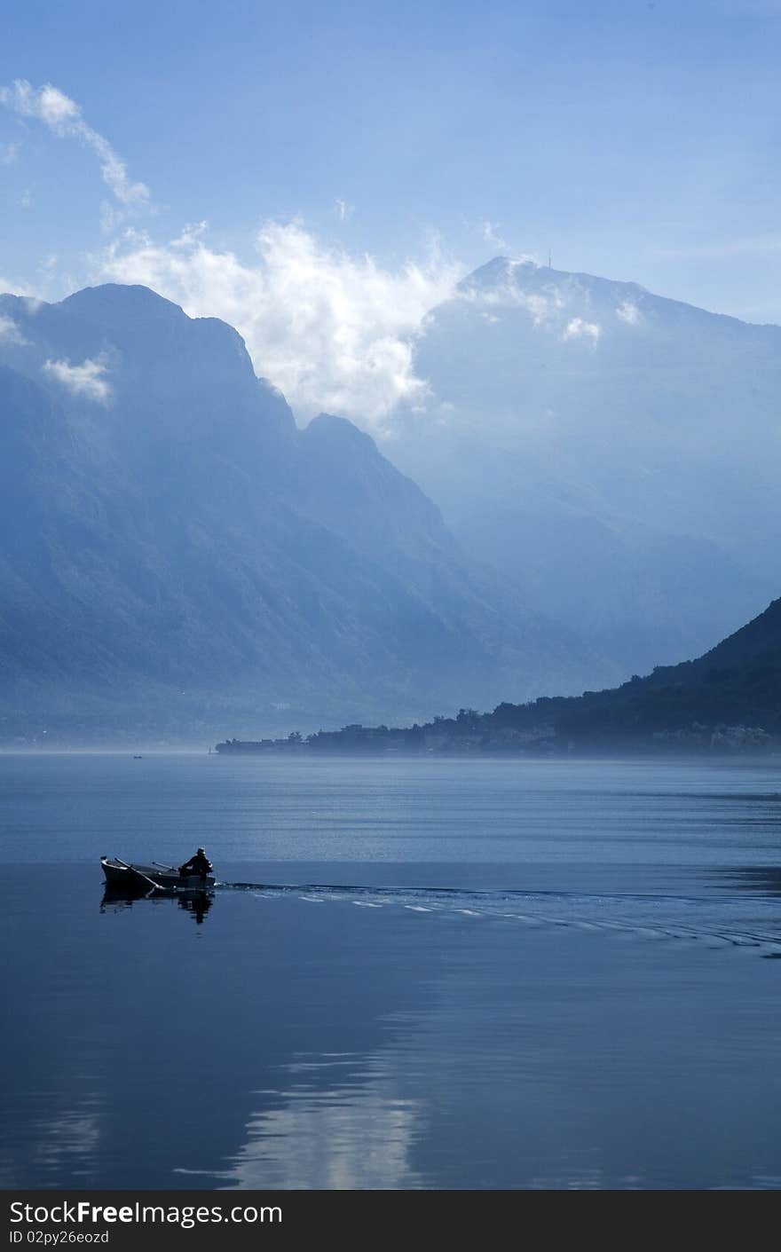 Boat in the Bay of Kotor and the mountains in the background