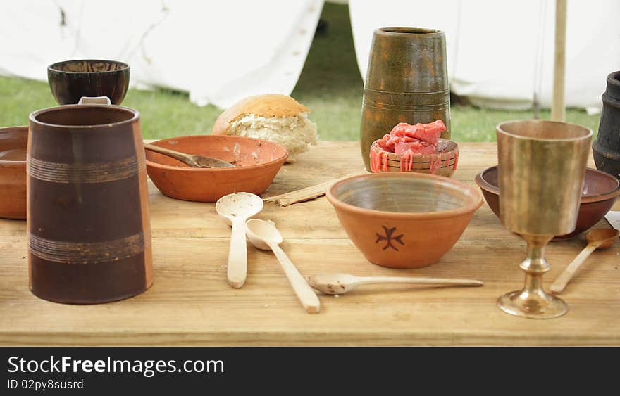 Dishes 13 th century on a wooden table. Historical reconstruction.