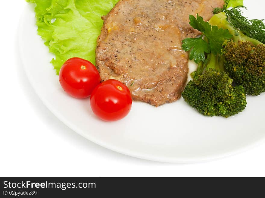 Escalope of veal with onion sauce and boiled broccoli isolated on white