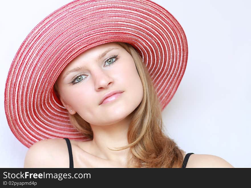 Portrait pretty woman in panama on blue background