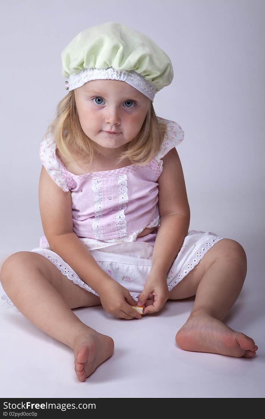 Small cute little girl sitting on the floor. Small cute little girl sitting on the floor