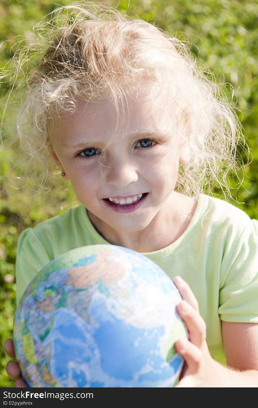 Little girl holding globe. Concept: Earth in future generations hands