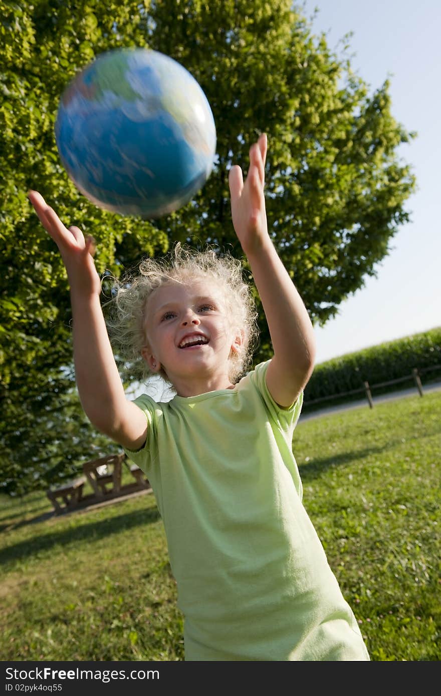 Little girl receiving the globe. Concept: earth in children hands