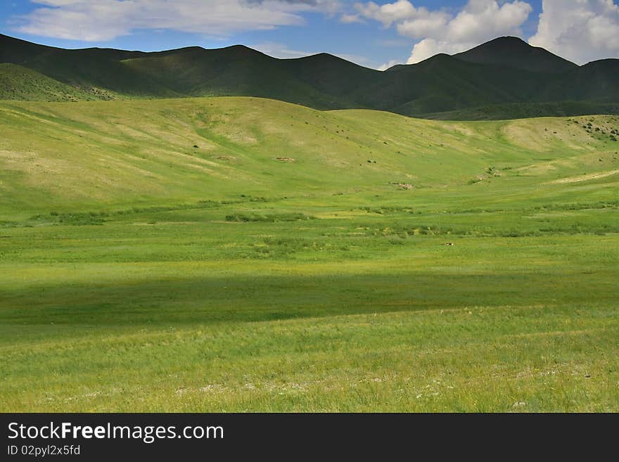 Beautiful green valley surrounded by high hills