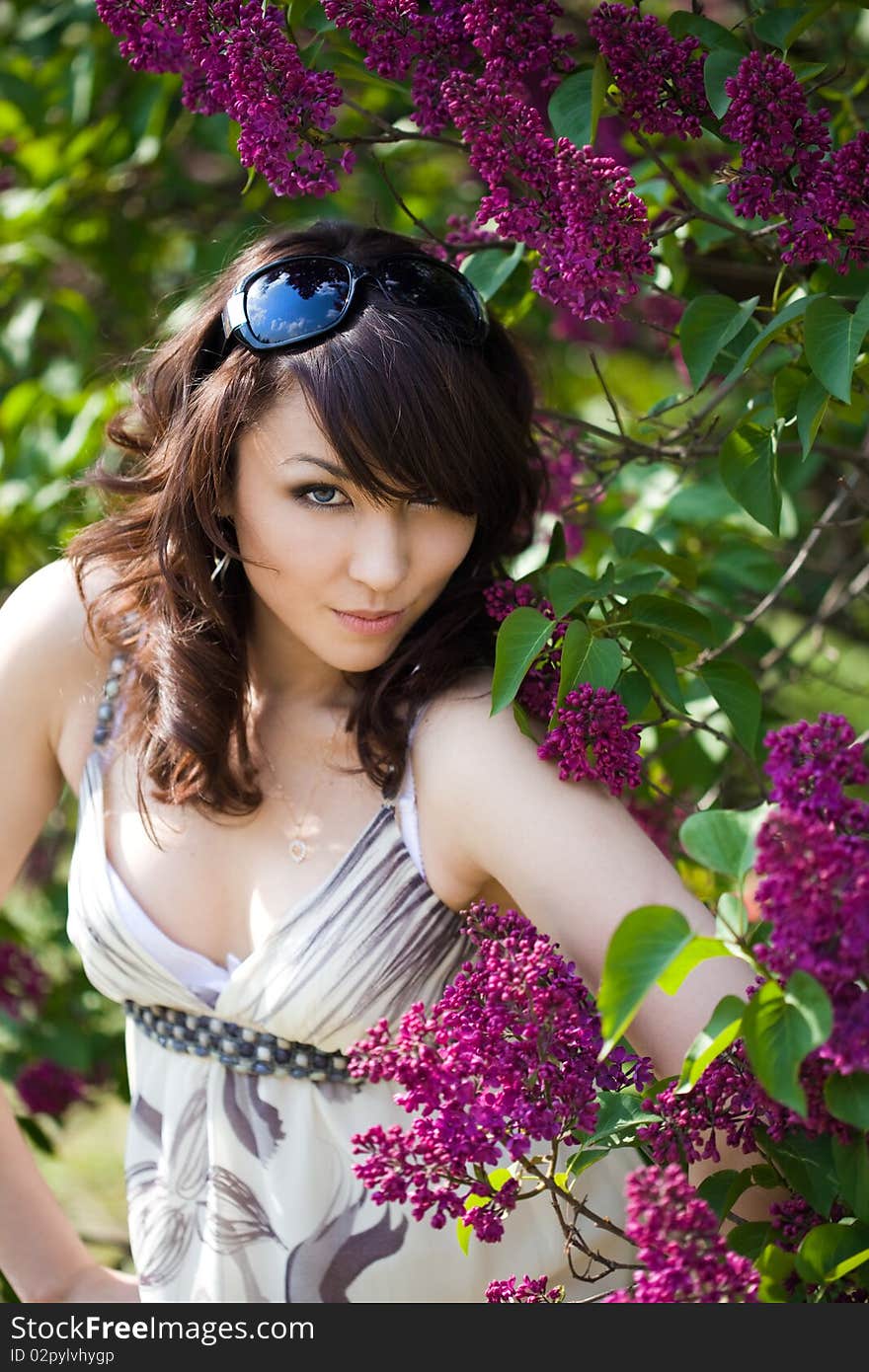 Tender girl in the garden with lilac