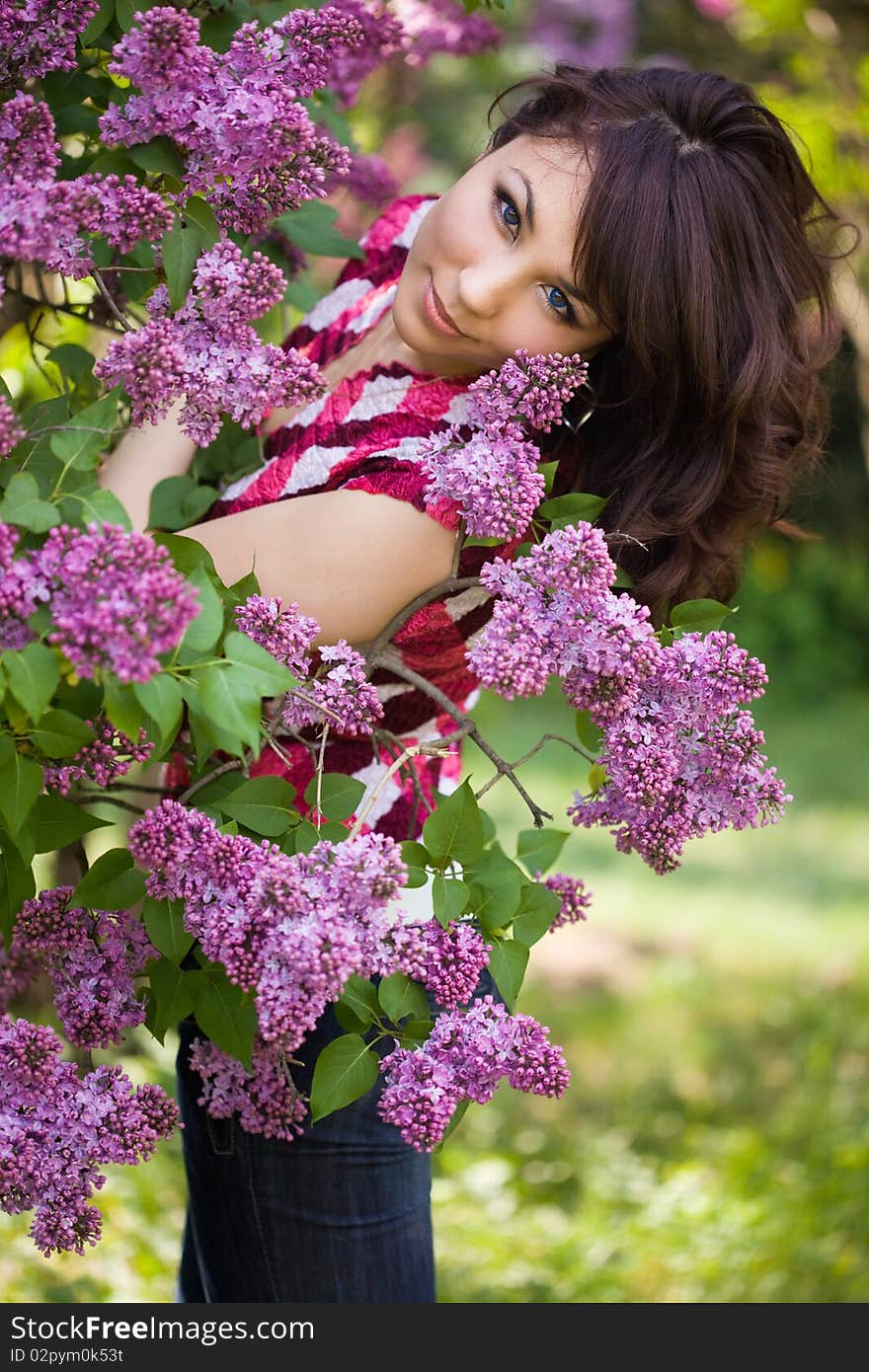 Tender girl in the garden with lilac