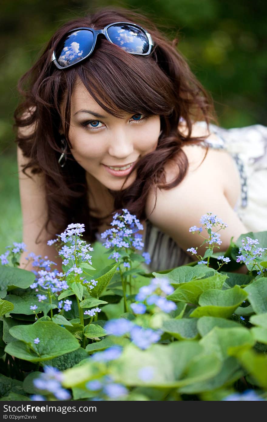 Tender girl in the garden with flowers