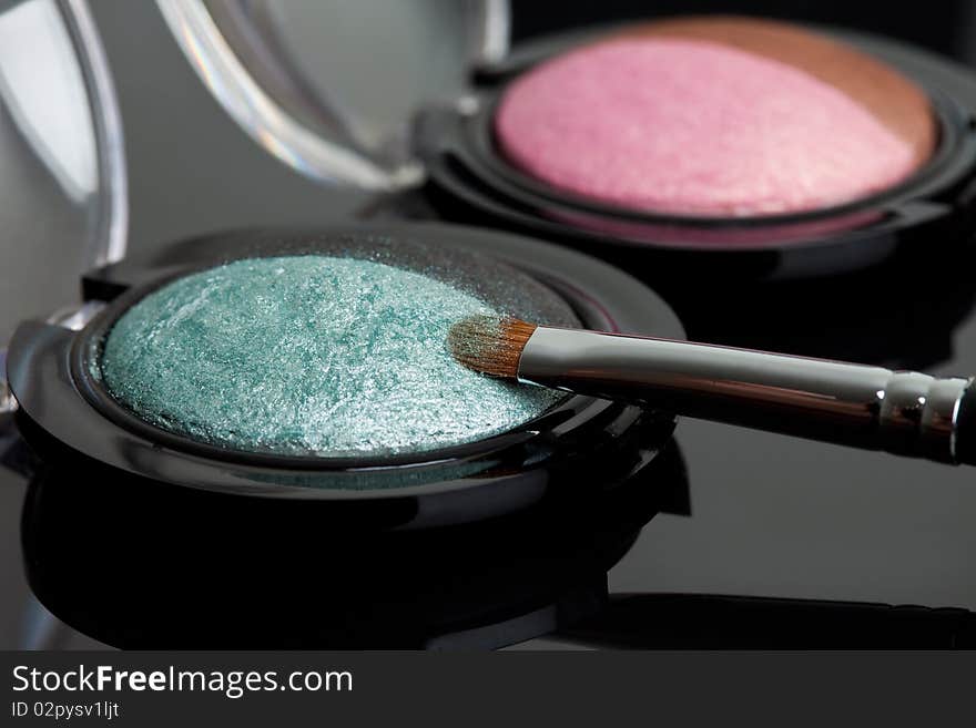 Make-up eyeshadows and cosmetic brush