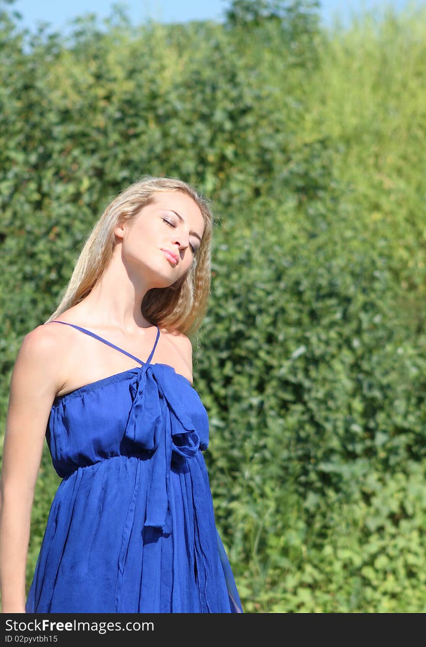 Blond girl in dark blue dress