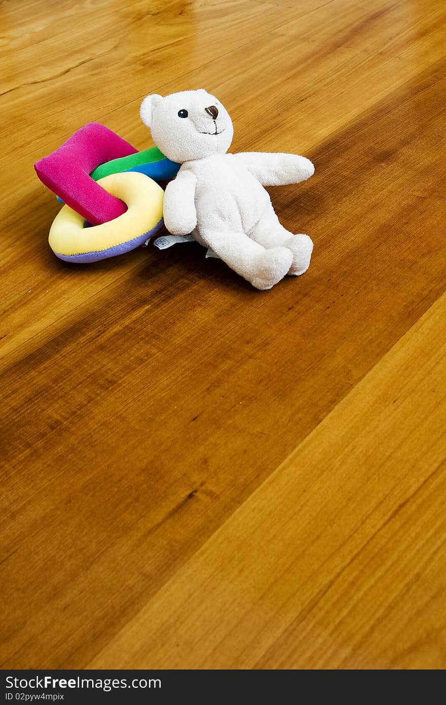 Bear and toy on wooden ground