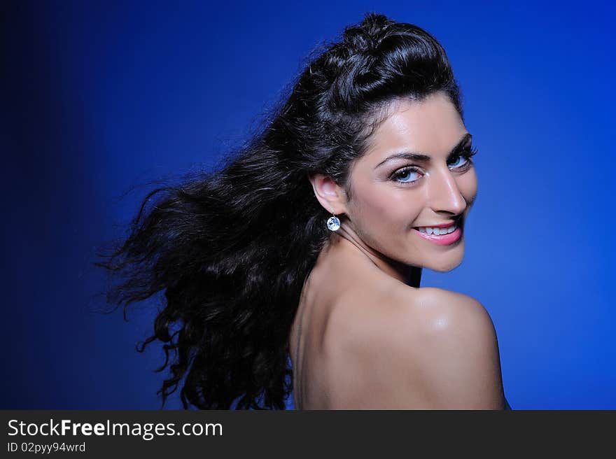 Beauty portrait of pretty woman with healthy long flying hair, pure skin and natural make-up. copy-space