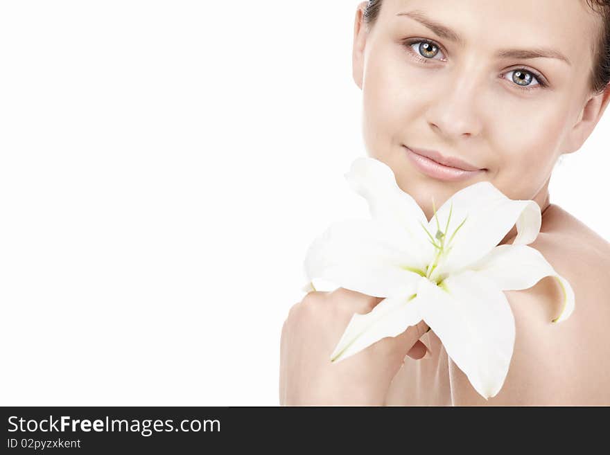 Young beautiful girl with a lily on a white background