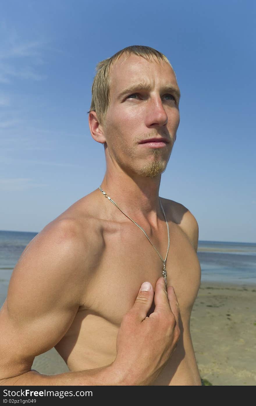 Young man with cross on the chest. Young man with cross on the chest.