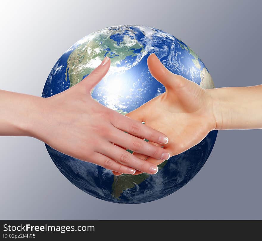 Business handshake on the background of the Earth. The symbol of a successful business.