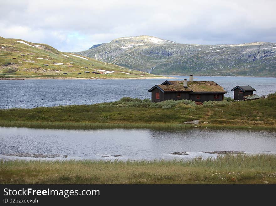 Traditional Norwegian House In Rugged Landscape