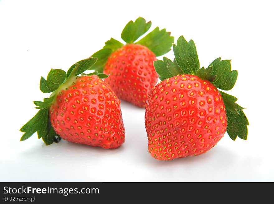 Three fresh strawberries isolated on white background. Three fresh strawberries isolated on white background.