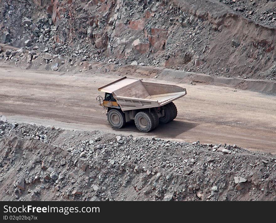 A Large Lorry Truck Driving on a Quarry Dirt Road. A Large Lorry Truck Driving on a Quarry Dirt Road.