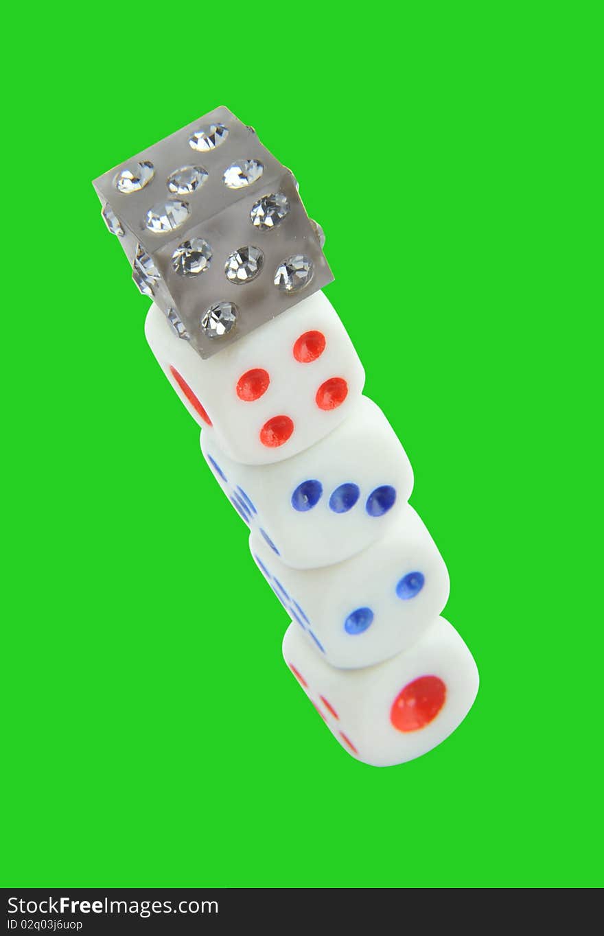 The dice isolated on a green background. The dice isolated on a green background