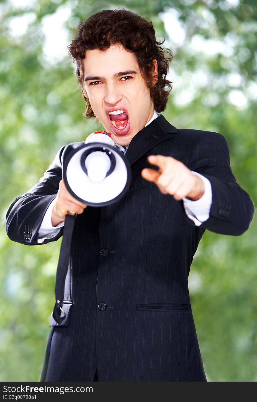 Portrait of a young businessman with megaphone