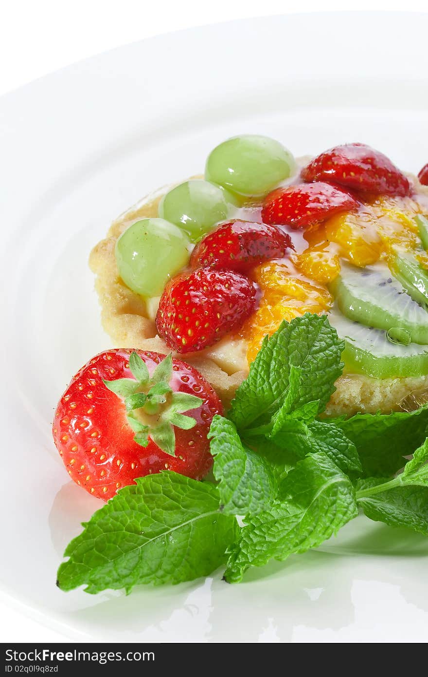 Fruit tart and fruits on a plate