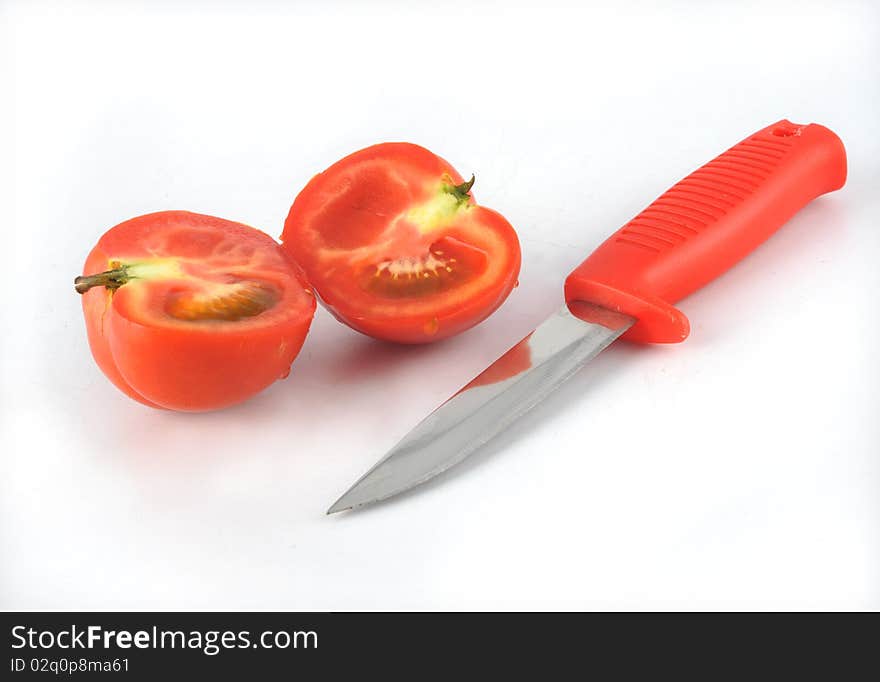 Tomato and knife in white background