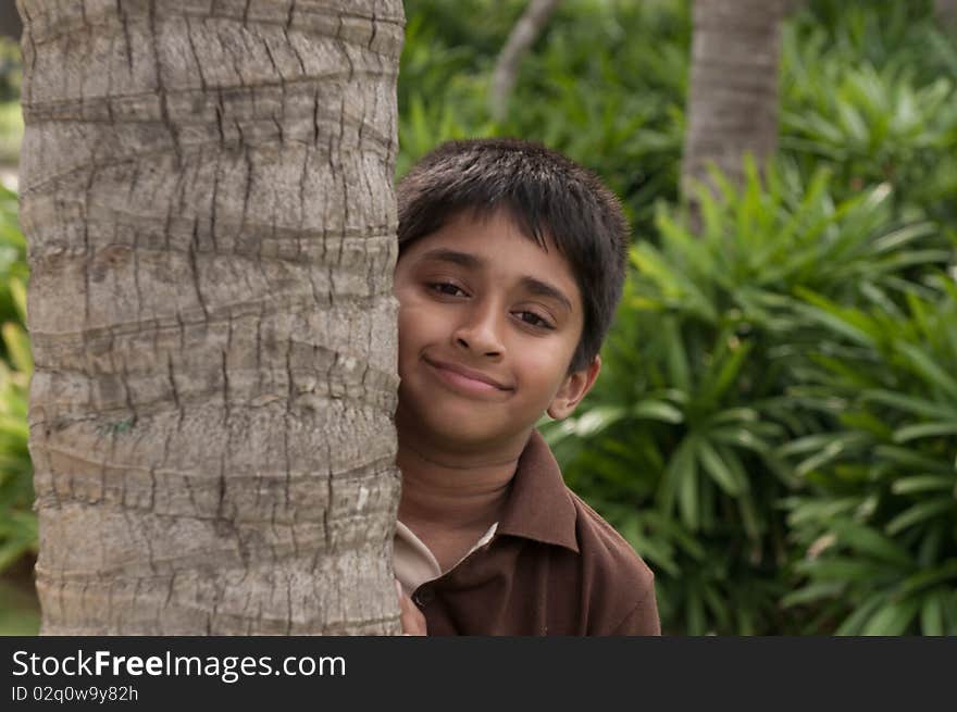 An handsome Indian kid peeping thru the trunk